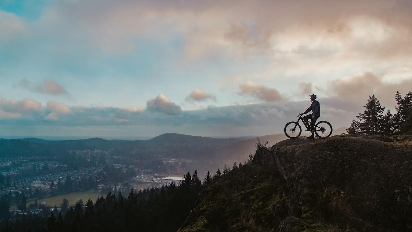 Mountain biker overlooking town of Langford on Vancouver Island