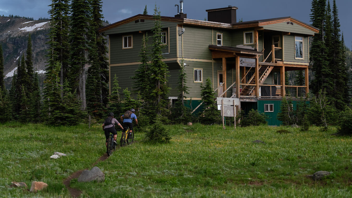 two riders approach sol mountain lodge in the monashee mountains