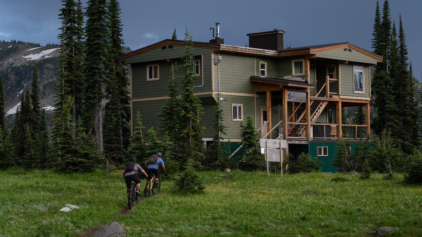 two riders approach sol mountain lodge in the monashee mountains
