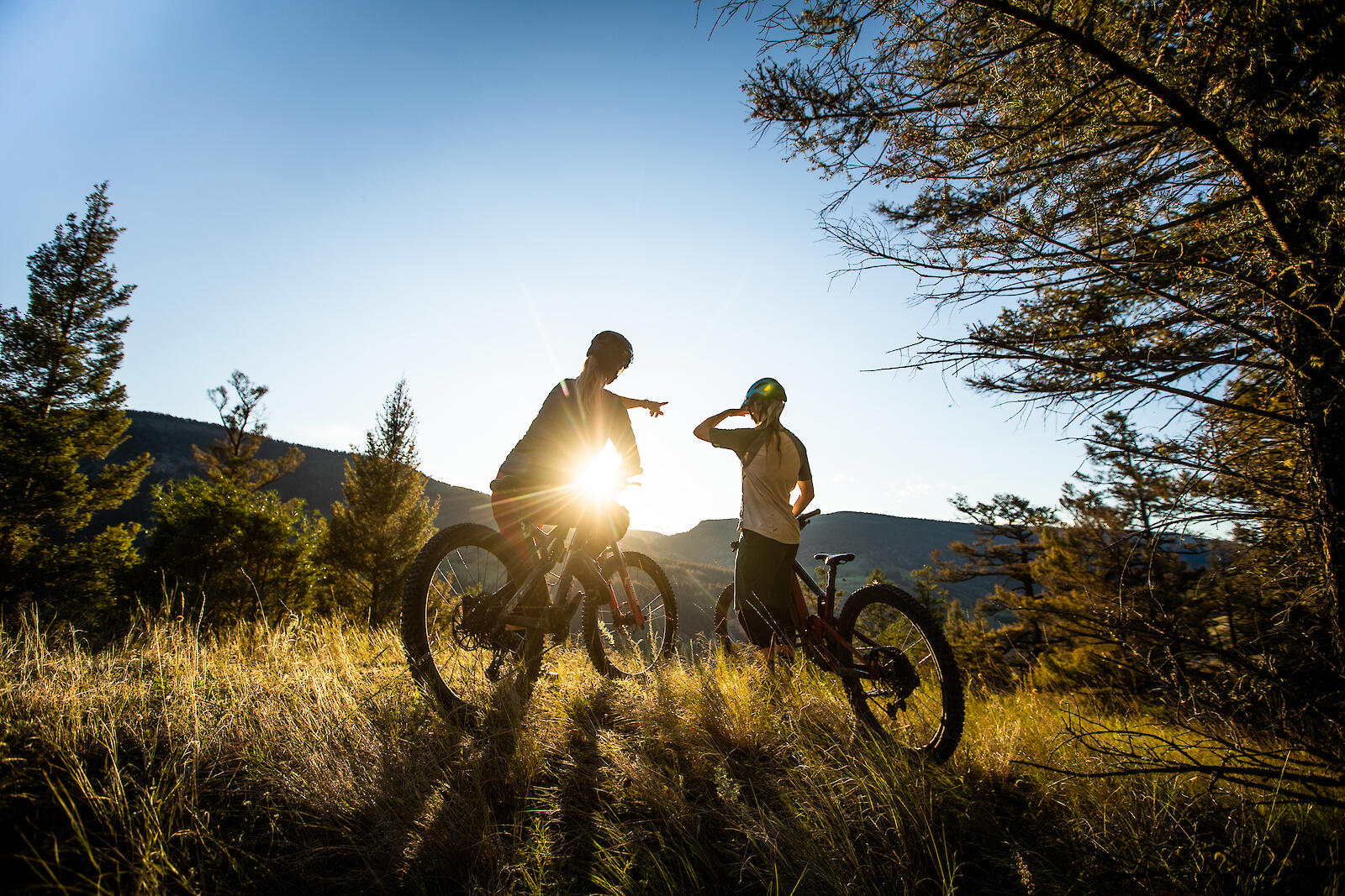 two bikers looking out at the hills