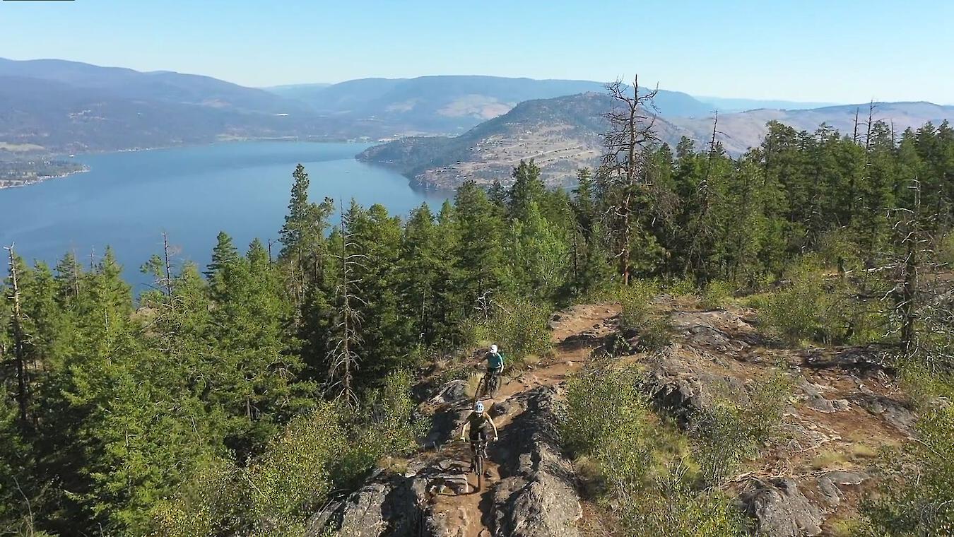 mountain bikes on trail above lake